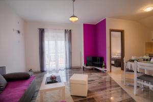 a living room with a purple accent wall at Arenta Apartments in Metković
