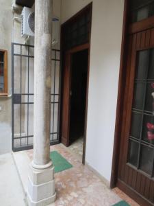 a column in front of a building with a door at Apartment Goldoni in Venice