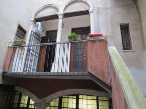a balcony of a building with two plants on it at Apartment Goldoni in Venice