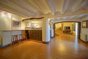 a large room with a tile floor and a ceiling at Casa Rustíca Cal Mian in Almoster