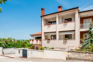 an apartment building with flowers on the balconies at Cerin Apartment in Rovinj