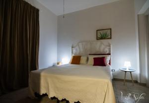 a bedroom with a large white bed with two pillows at B&B Villa Sofia in Novoli +55 photos