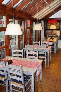 a restaurant with tables and chairs and lights at Hotel Plaza in Lommel