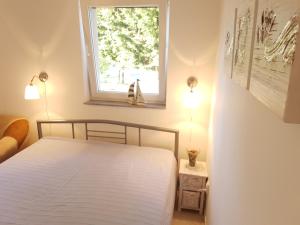 a bedroom with a white bed and a window at Olive Apartments in Ugljan +118 photos