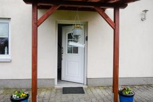 a front door of a house with a wooden pergola at Am Zirkelstein 38 b in Schöna