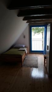 a bedroom with two beds and a large window at Blue Bird in Pluski