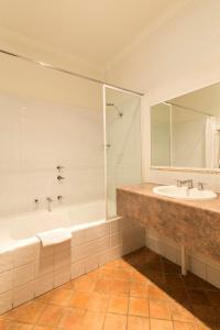 a bathroom with a tub and a sink and a mirror at Stay Margaret River in Margaret River Town