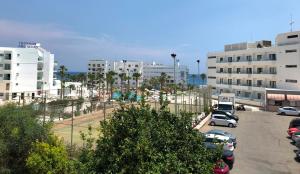 a parking lot with cars parked in front of buildings at Cassa de Flamingo in Protaras