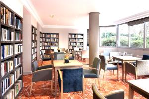 a library with chairs and tables and bookshelves at Domitys Paris Plaisance in Paris +4 photos