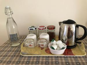 a tray with a tea kettle and eggs and a bottle at Fair View in Marden