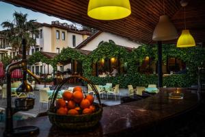 a basket of oranges on a table in a restaurant at Bezay Hotel in Fethiye