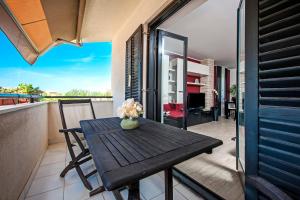 a table on the balcony of a house at Cerin Apartment in Rovinj