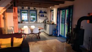 a kitchen with a table and white chairs in it at Blue Bird in Pluski