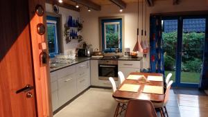 a kitchen with a table and a table and chairs at Blue Bird in Pluski +36 photos