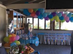 a birthday party with balloons and a table with at Ariadnes Holiday Accommodation I in Apidias Lakos