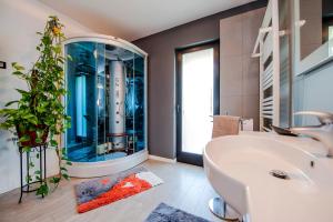 a bathroom with a large tub and a plant at Cerin Apartment in Rovinj +51 photos