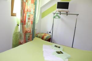 a room with a bed with a laptop on top of it at Motel Lepo Mesto in Strmosten