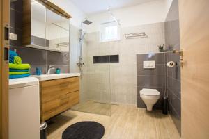 a bathroom with a shower and a toilet and a sink at Cozy Coastal apartment GaMa in Split