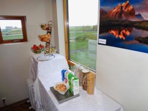 a room with a table with food and a refrigerator at Hali Country Hotel in Gerdi