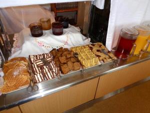 a buffet with many different types of pastries and cookies at Hali Country Hotel in Gerdi