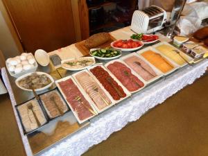 a table with many different types of food on it at Hali Country Hotel in Gerdi