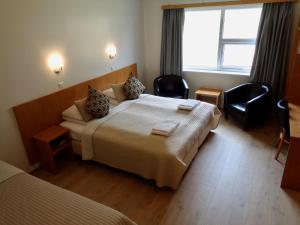 a hotel room with two beds and a window at Hali Country Hotel in Gerdi