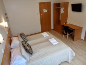 a hotel room with a bed with a tie on it at Hali Country Hotel in Gerdi