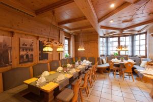 a dining room with tables and chairs and windows at Löwen Hotel & Restaurant in Wendlingen am Neckar