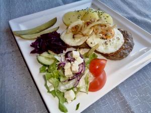 a plate of food with shrimp and a salad at Hali Country Hotel in Gerdi