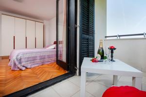 a room with a white table and a bed at Cerin Apartment in Rovinj