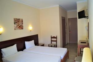 a bedroom with a bed and a desk and a chair at Brati - Arcoudi Hotel in Arkoudi +72 photos