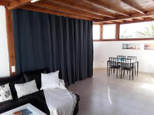 a living room with a couch and a table at Las Arecas Loft in Playa Blanca