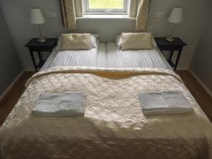 a bedroom with two beds with towels on them at Hali Country Hotel in Gerdi