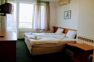 Postel nebo postele na pokoji v ubytování R&G Hotel