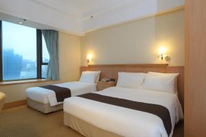 Postelja oz. postelje v sobi nastanitve Ramada Hong Kong Grand View