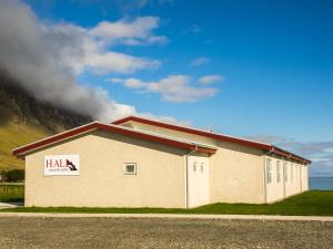 a building with a sign on the side of it at Hali Country Hotel in Gerdi