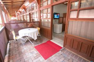 a room with a table and a door with a red rug at çarşı pansiyon in Amasra