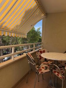 a balcony with a table and chairs and a window at Apartment Sanja in Baška Voda