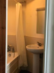 a bathroom with a sink and a shower curtain at The Manchester Hotel in Bournemouth