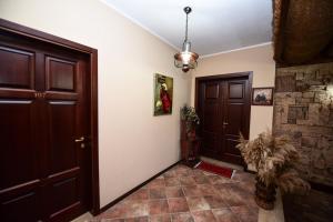 a hallway with two brown doors and a tile floor at Real Scampis Hotel in Elbasan