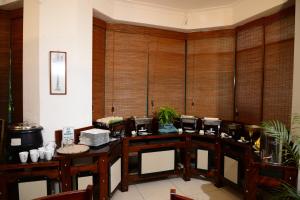a dining room with wooden walls and wooden tables at The Royal Mall in Kandy
