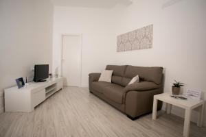 a living room with a couch and a tv at Aria Di Mare B&b in Marsala