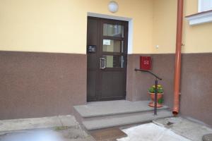 una puerta a un edificio con una maceta delante en Vee 4 City Center Apartment en Pärnu