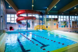 a large swimming pool with a water slide at Pokoje gościnne OSiR in Zamość