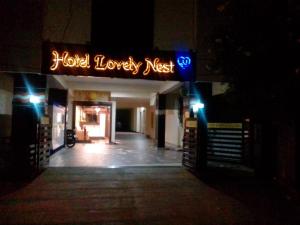 a hotel lobby with a sign that reads hotel luxury nest at Hotel Lovely Nest in Coimbatore