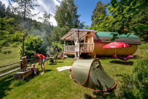 a group of people in a yard with a tent at Fasslhütte in Murau