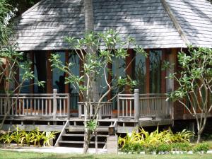 a porch of a house with a tree at New Ozone Resort & Spa in Ko Lanta