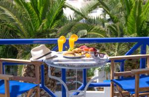 a table with a bowl of fruit and a hat on it at Syros Atlantis in Vári