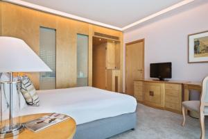 a hotel room with a bed and a television at Melia Athens in Athens