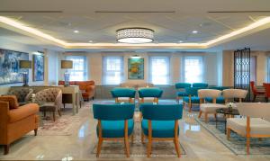 a waiting room with blue chairs and a waiting area at Millennium Istanbul Golden Horn in Istanbul